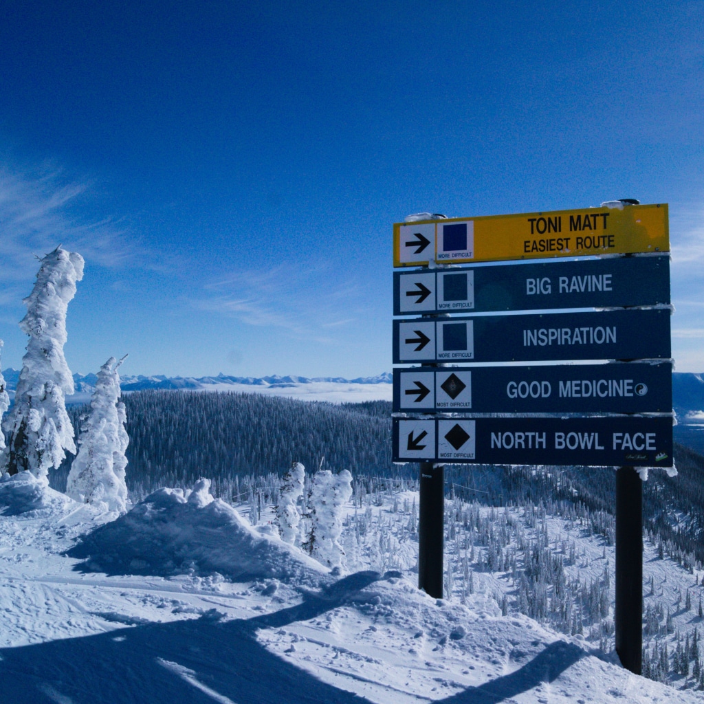 From the top of Whitefish Mountain Resort -- looking to the southeast a view of mountain valley, snowghosts, and a ski trail sign