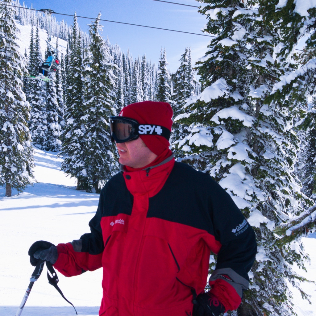 Skier wearing red and black looking to the left